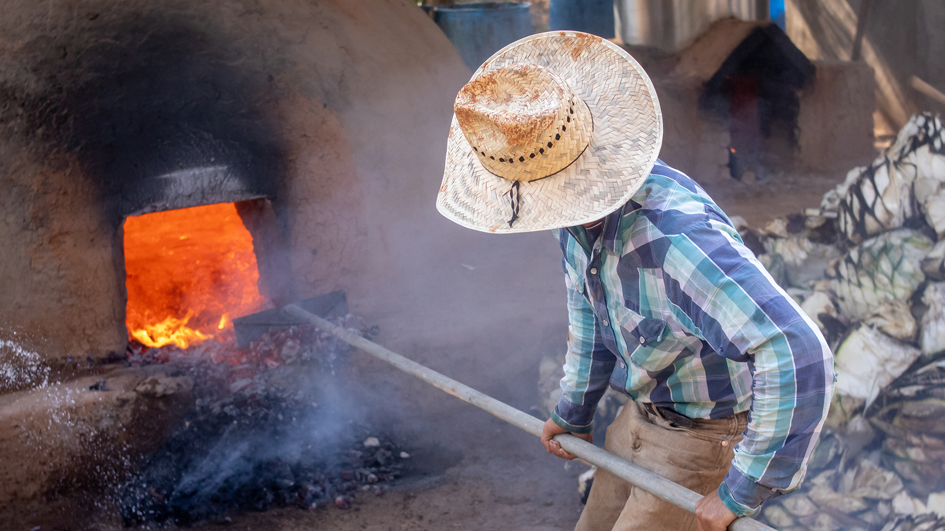 A person working with an adobe oven.
