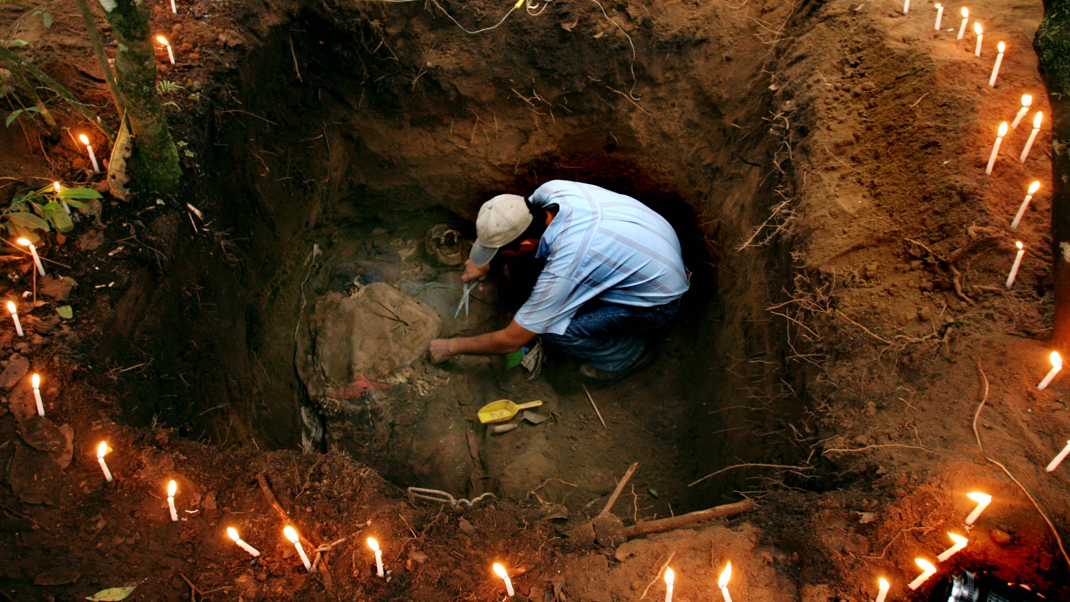 A forensic anthropologist works to exhume the body of a peasant killed by the Guatemalean army in 1982 during the civil war.