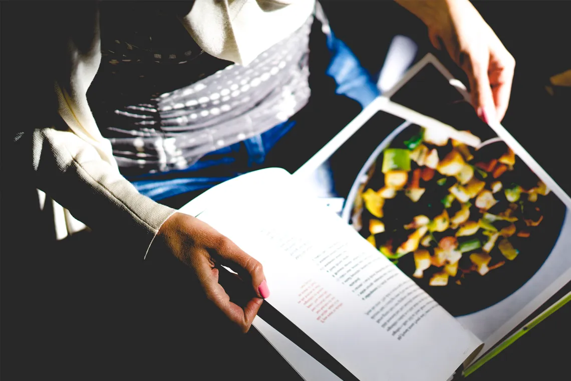 Woman looking at magazine about food